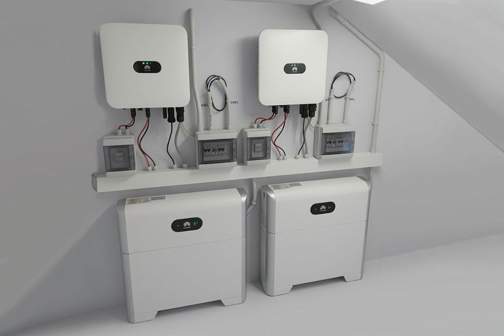 Installazione a parete con due inverter Huawei SUN2000, due moduli di batterie di accumulo Huawei LUNA2000 e quadri elettrici di sezionamento per impianto fotovoltaico domestico.